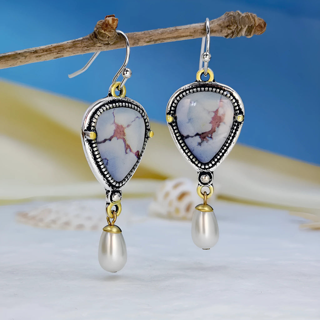 Retro blue drop earrings with synthetic blue opal and white pearl on a geometric metal setting.
