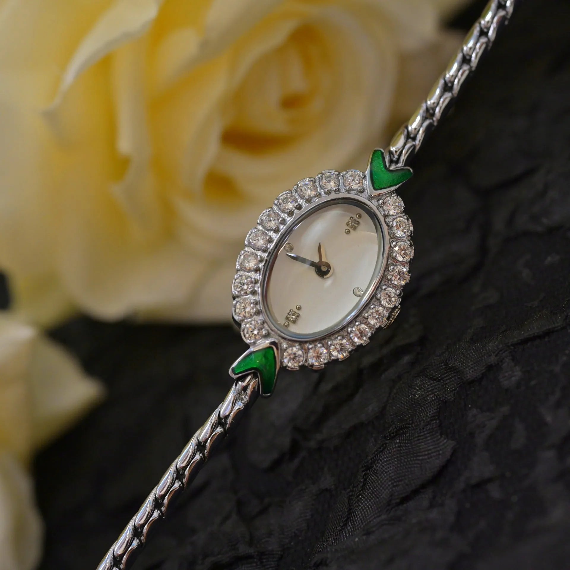 European small gold women's watch with handmade rhinestone inlay and adjustable strap on light background