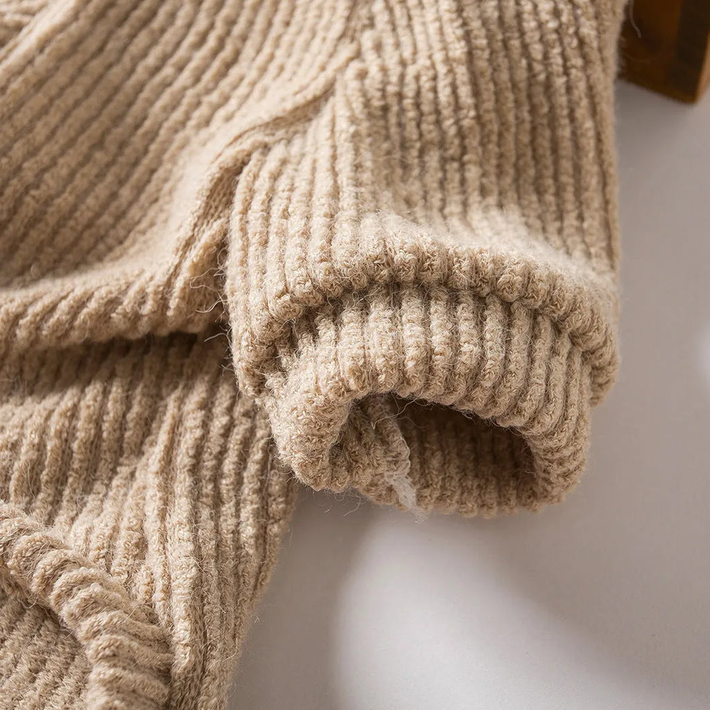 Brown cloth dog pullover sweater on a small white dog, showing casual style.
