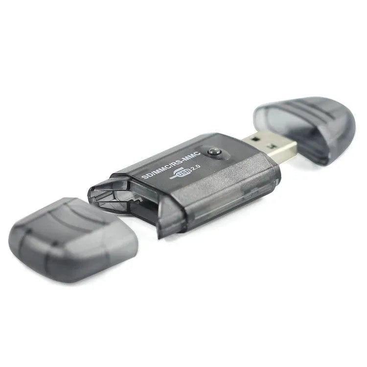 Transparent plastic USB card reader with LED light on a desk.