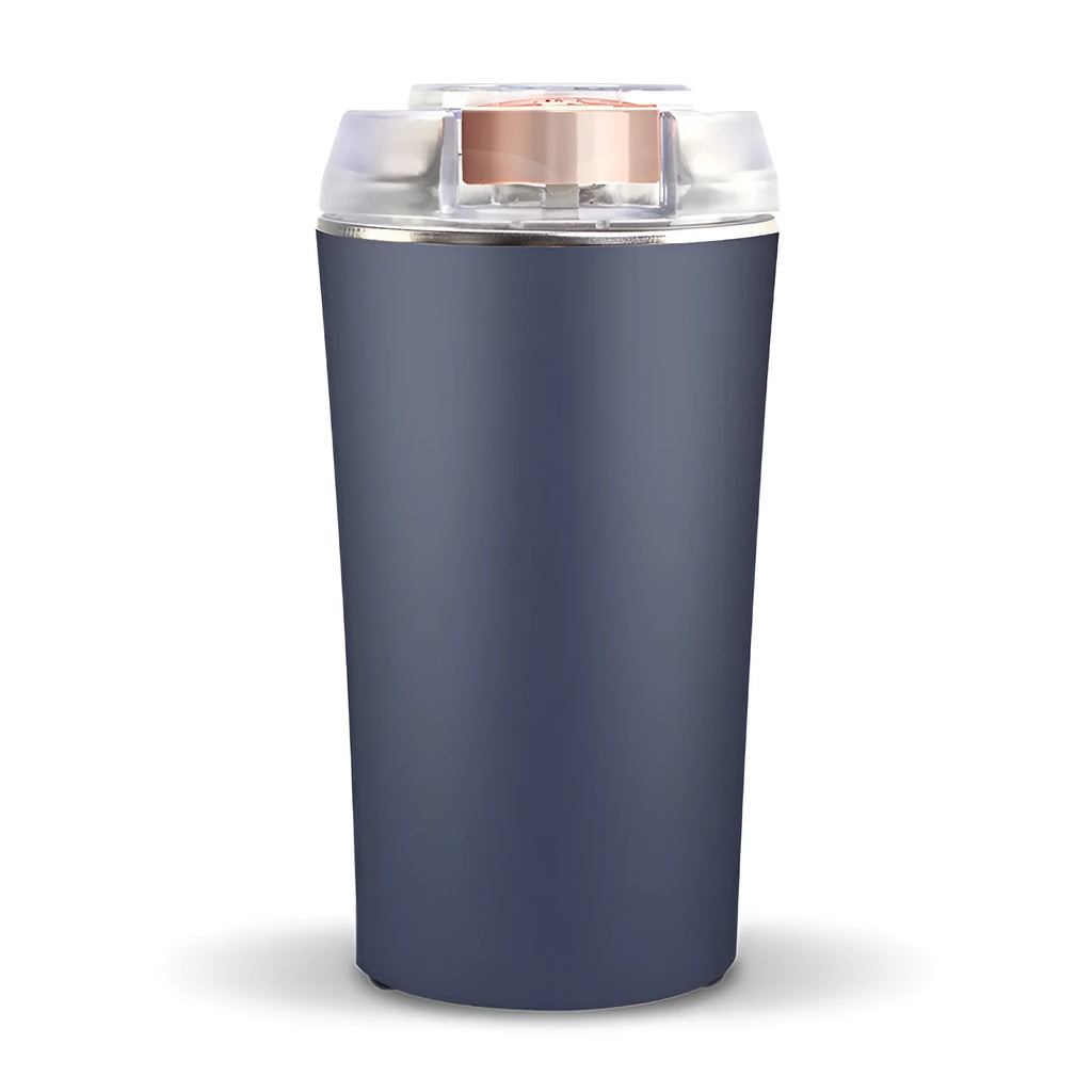 Blue mini flour mill and grain crusher with stainless steel blades on a kitchen countertop.