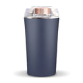 Blue mini flour mill and grain crusher with stainless steel blades on a kitchen countertop.