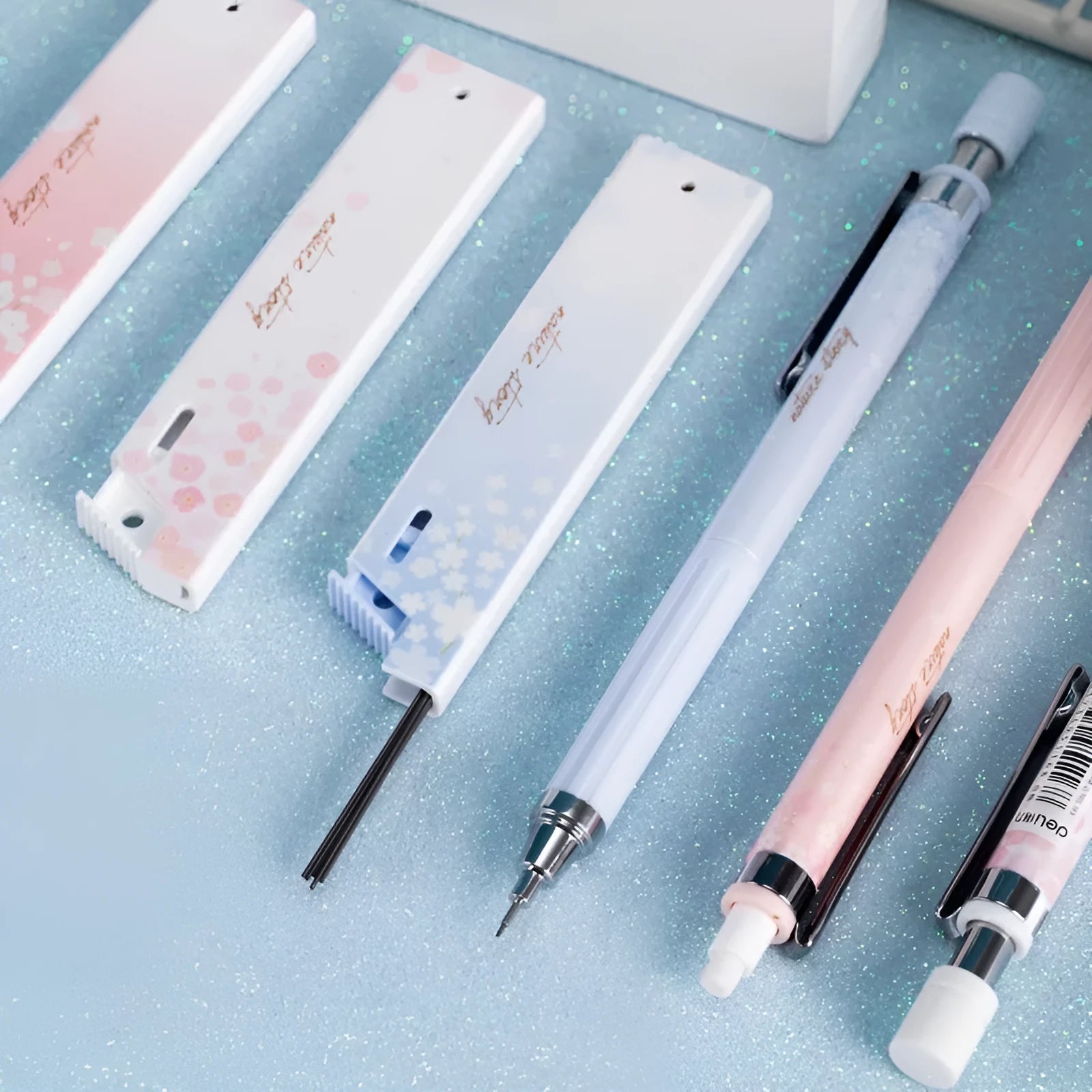 Simplified cartoon-style automatic pencil set with three pens and three boxes of HB lead refills.