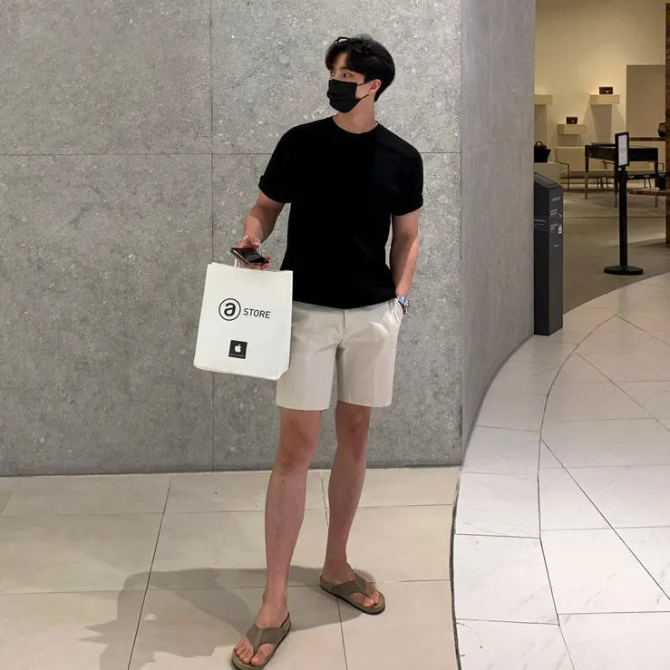 Men's straight-leg casual shorts in solid black, white, or khaki colour made from polyester fabric.
