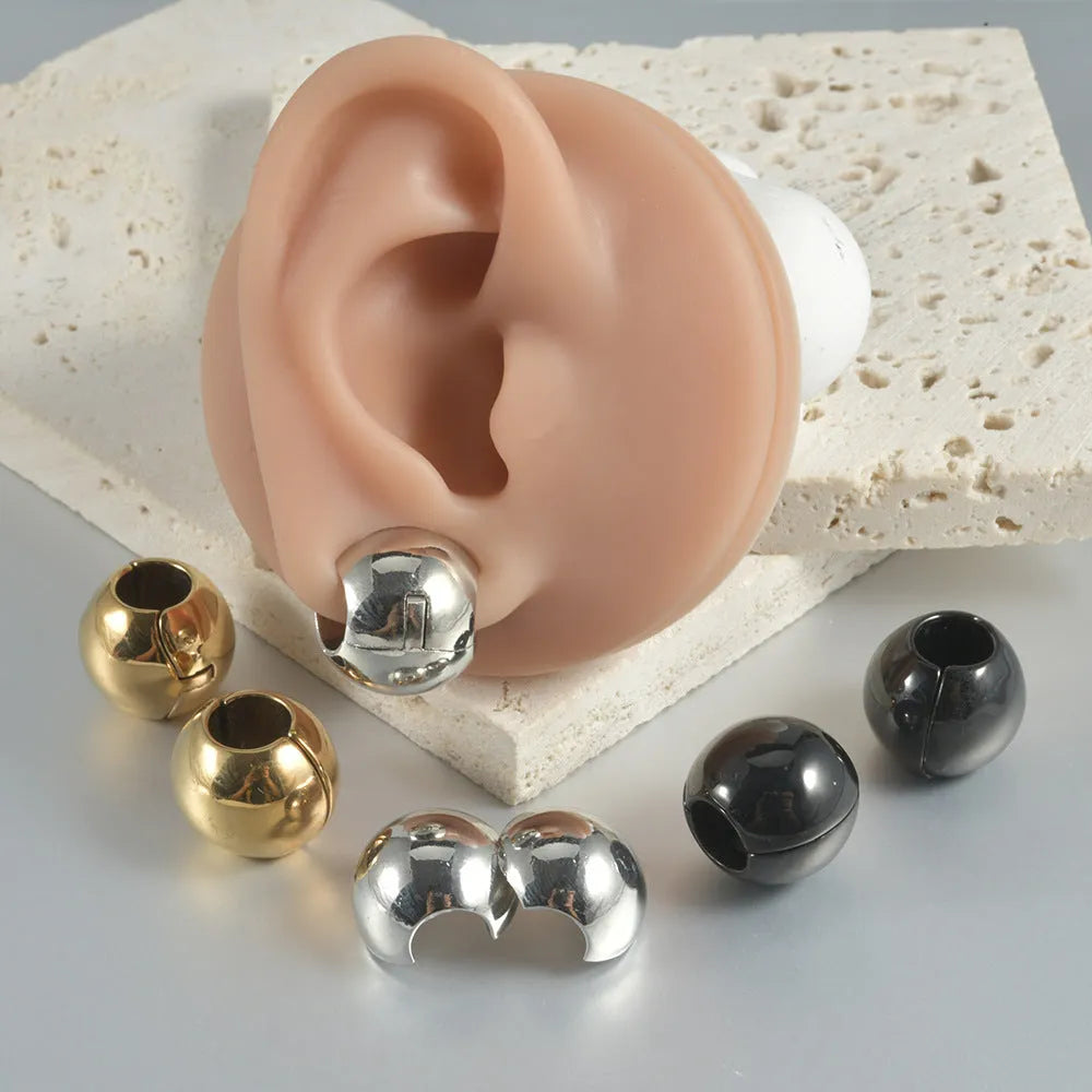 Stainless steel hollow skull Buddha earrings in hip hop style, showing geometry design.