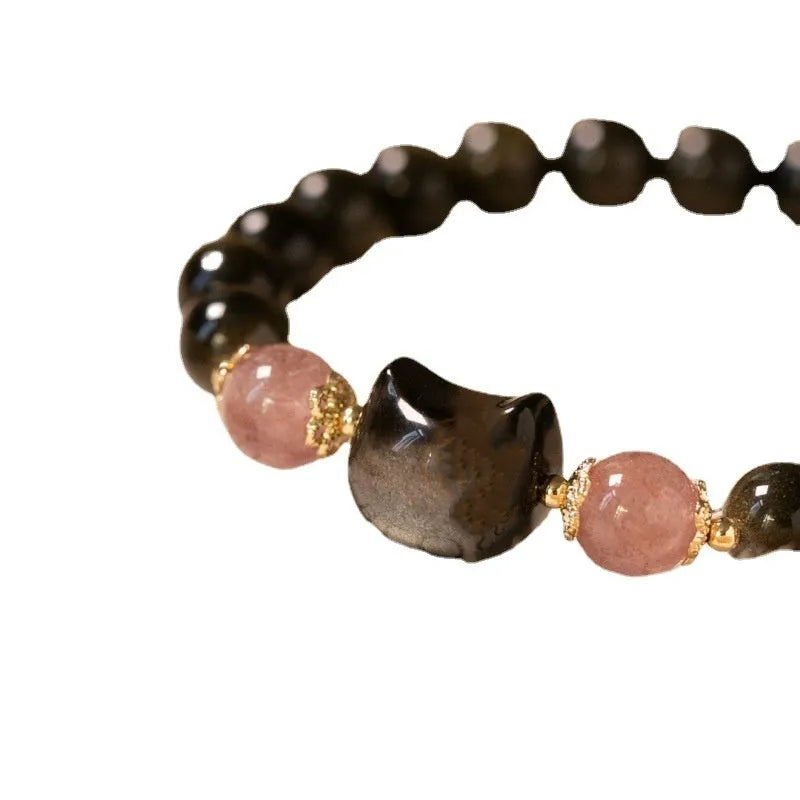 Black natural obsidian bead bracelet with a kitty charm on a stretch cord.