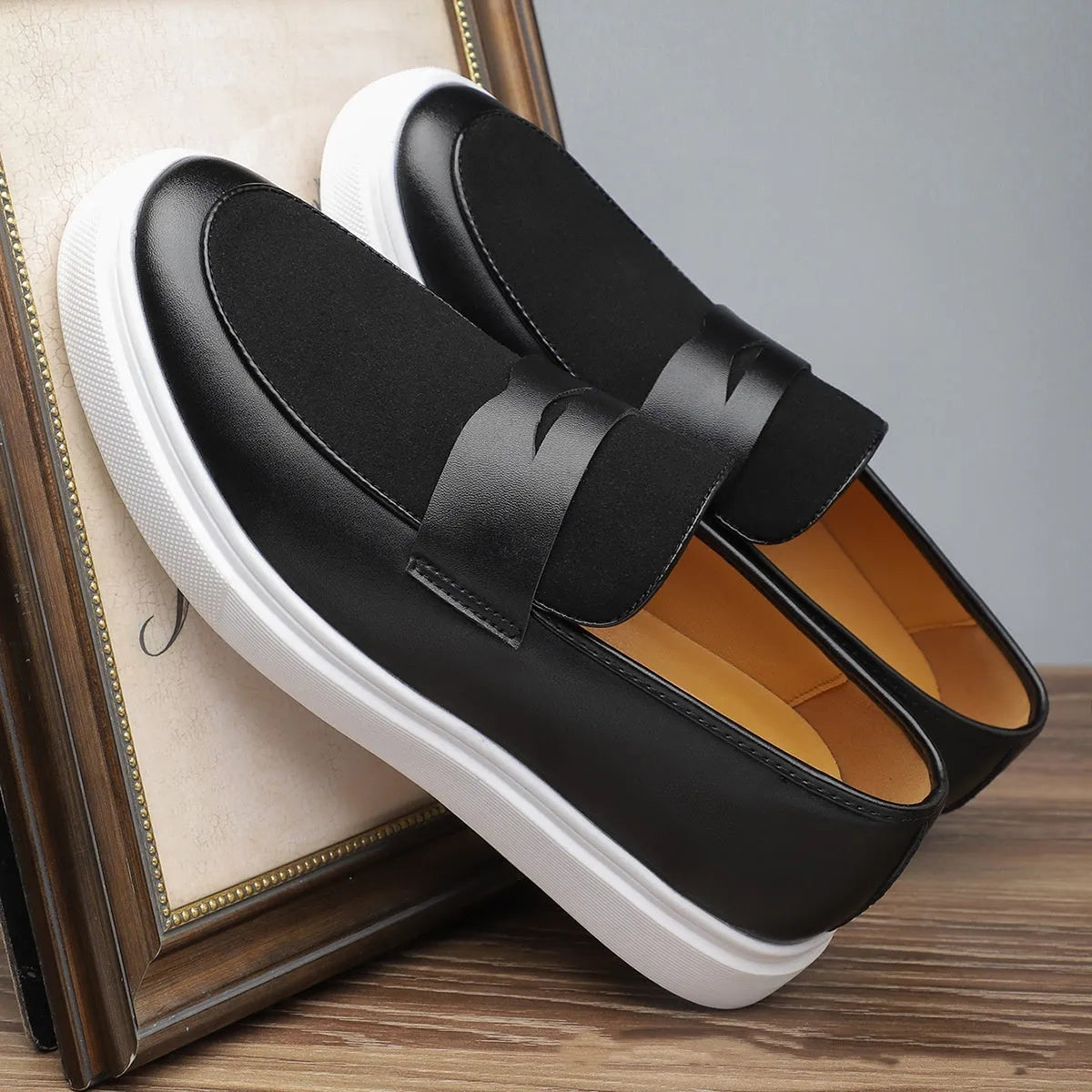 Black men's slip-on casual shoes with tassel detailing and a round toe