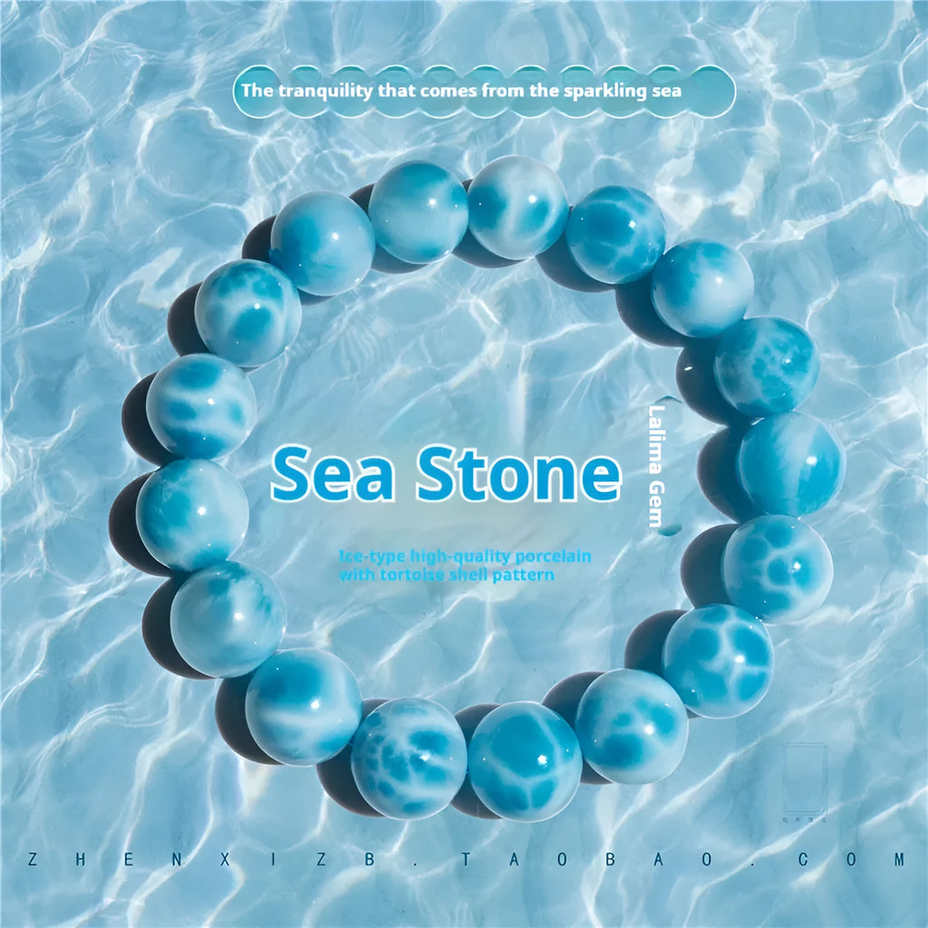 Blue bodhi bracelet with natural sea-pattern crystal stones and a single pearl bead.