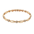 Golden coloured hollow carved copper bracelet with a U-shaped bangle profile on a white background.