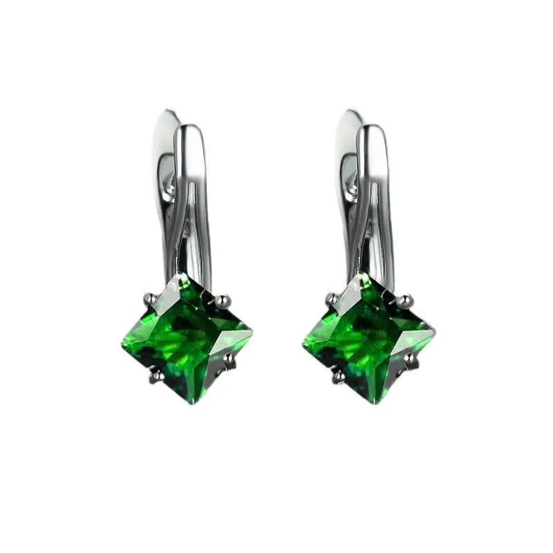 A pair of simple copper earrings with a diamond design created from inlaid zircon stones.