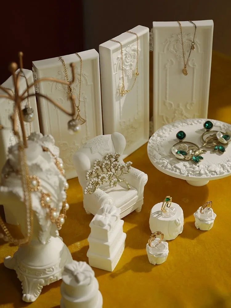 White plaster retro jewellery display stand with three layers, neutral background for necklace display