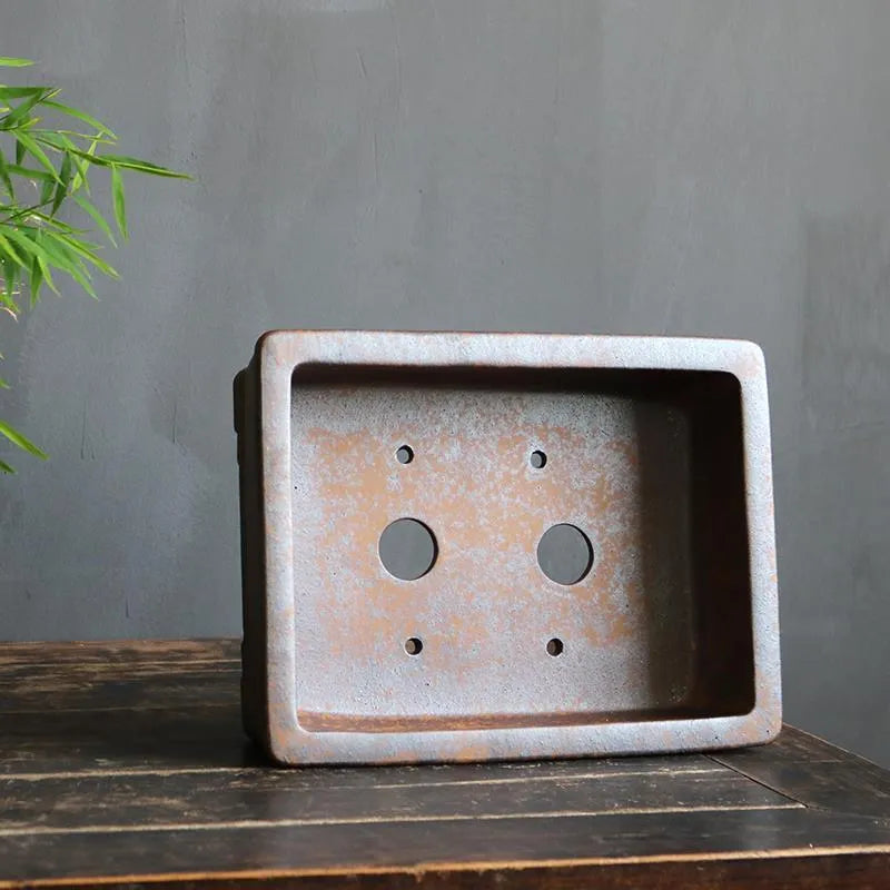 Rectangular unglazed purple sand bonsai pot showing simple design and base with five drainage lines.