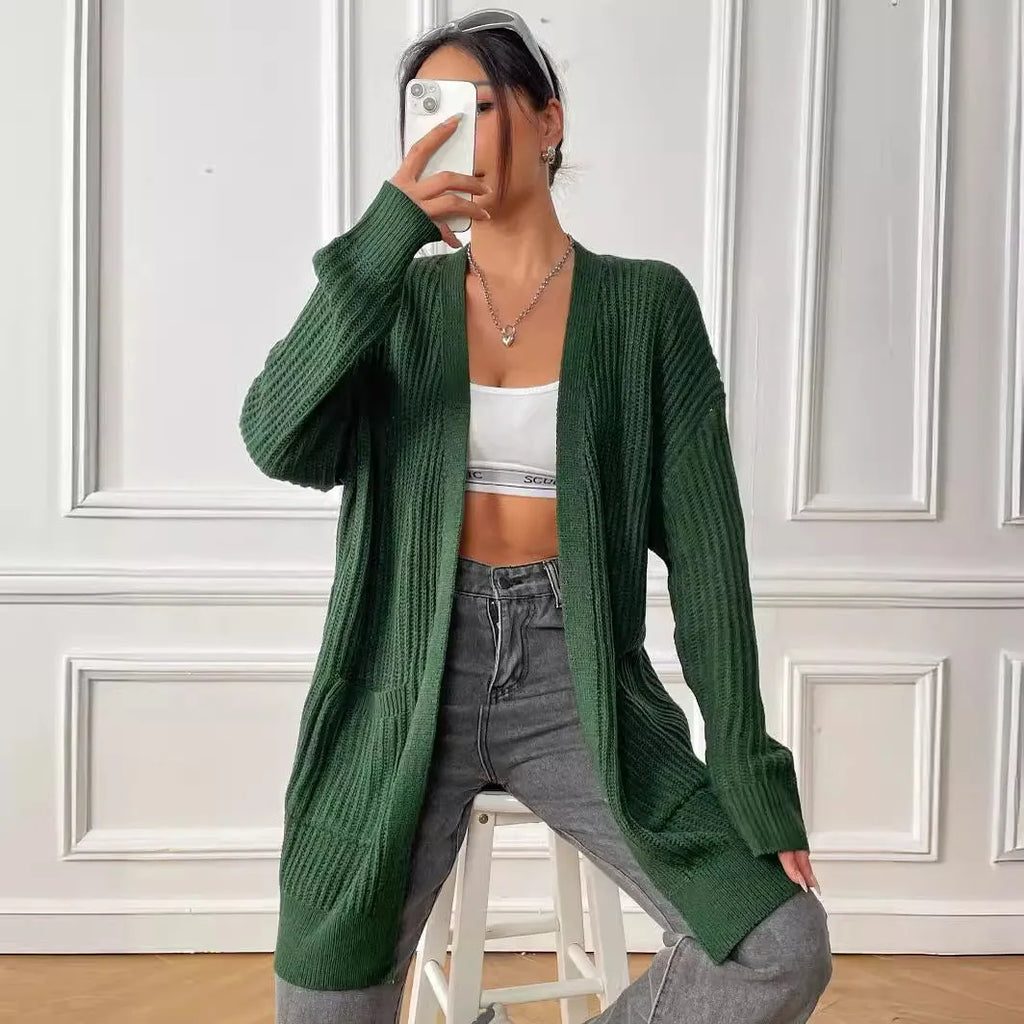 A dark green loose-fit women's cardigan sweater with two front pockets and long sleeves.