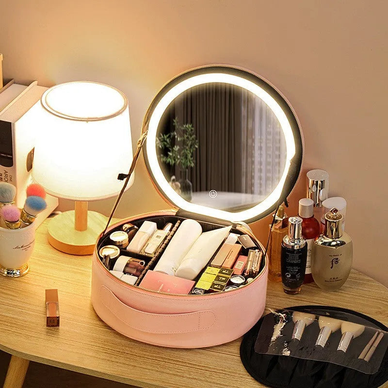 Round pink PU leather makeup bag open showing illuminated mirror and internal partitions.