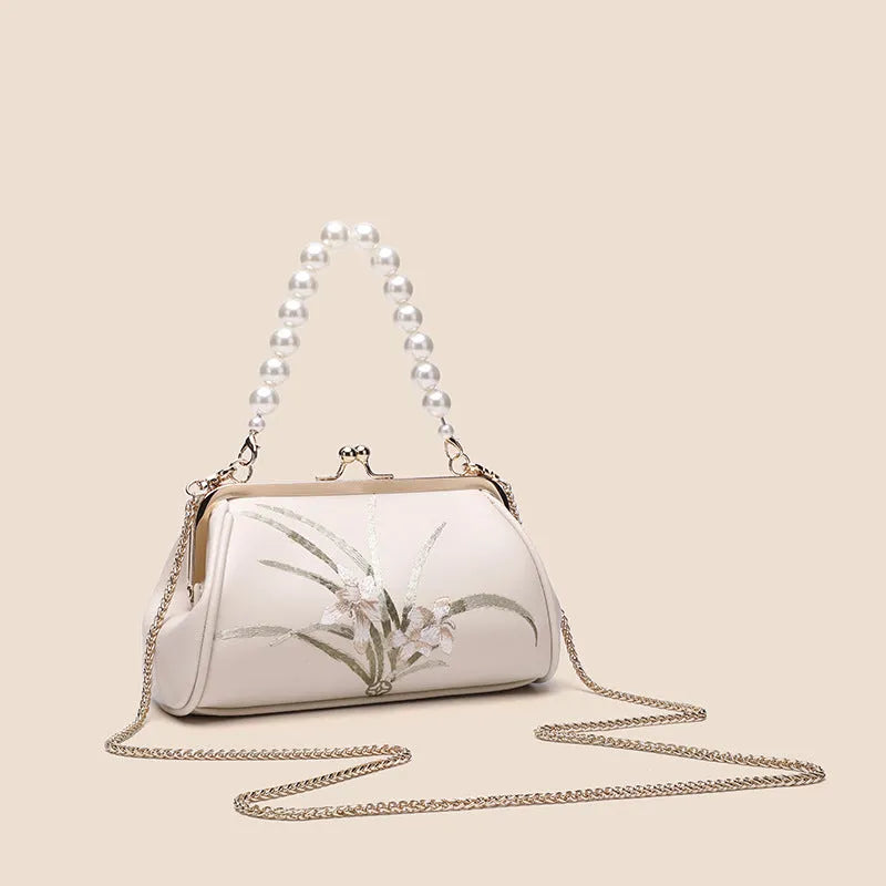 Beige women's embroidered shoulder bag with shell shape design made from soft PU leather