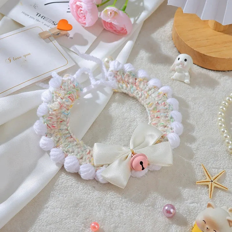 Handmade woven wool cat collar with embroidered cartoon British Shorthair kitten in pink, white, and yellow colours.