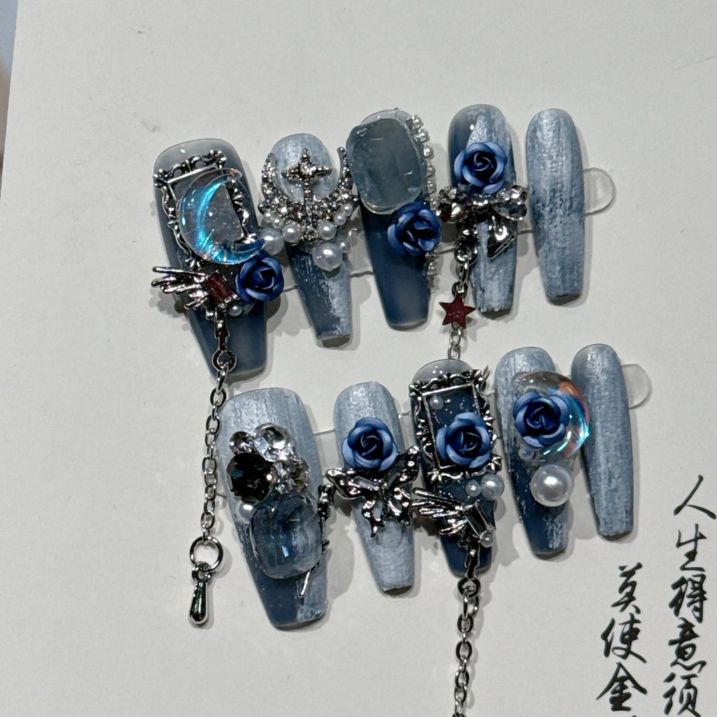 Ornate rose and tulip pattern nail wraps in deep blue night colour on a plastic armour suit.