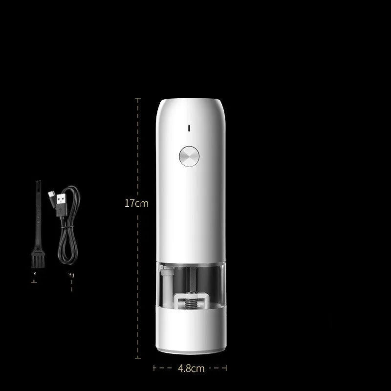 Black and silver electric pepper and salt grinder set with clear acrylic body on a kitchen counter.