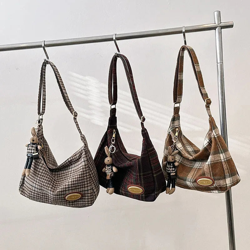 Women's woolen shoulder bag in horizontal square shape with cross-body strap and decorative sewing lines