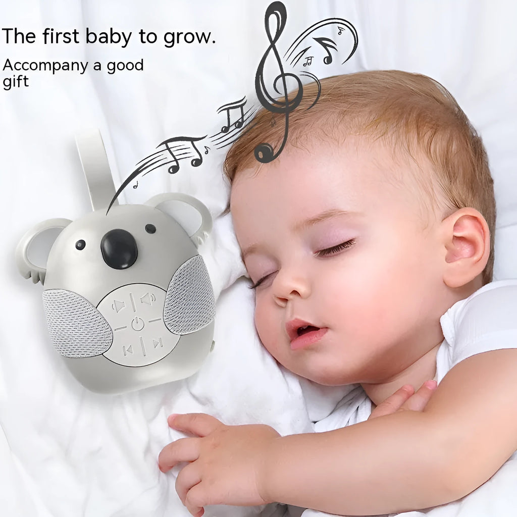 Koala-shaped infant white noise player toy in fox colour on a surface