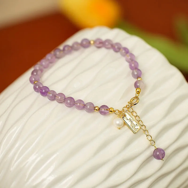 Women's natural crystal bracelet with lavender amethyst stones and animal zodiac design