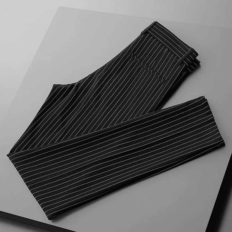 Man wearing thin striped loose-fit casual trousers in a drape style, shown in black and white colour options.