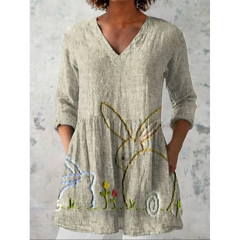 A loose-fitting women's dress with a wave print, 3/4 sleeves, and a wide waist.