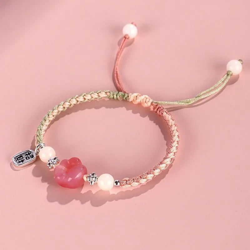 Red cat's paw charm couples bracelet with pink woven base, handmade glass and glaze jewellery