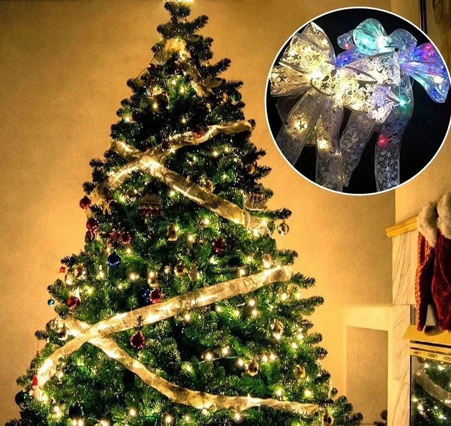 Christmas fairy light string with cloth ribbon bow tie decoration in gold or silver colours.