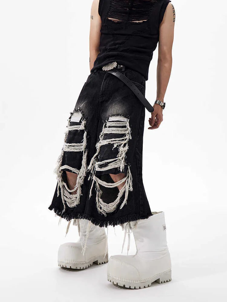 Black wide-leg cropped jeans with distressed patchwork detail and a mid-high waist.