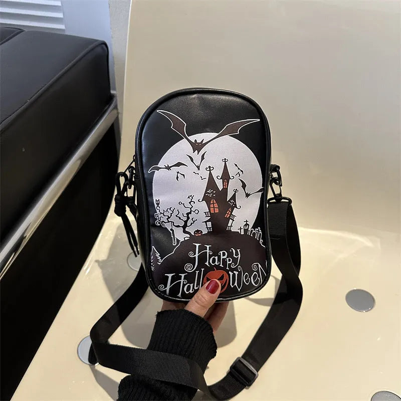 Black Halloween graffiti crossbody bag with cartoon pumpkin, ghost, and bat print, shown with adjustable strap.