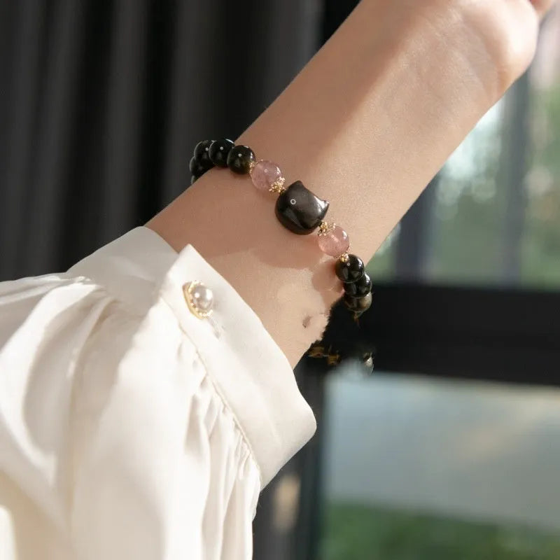 Black natural obsidian bead bracelet with a kitty charm on a stretch cord.