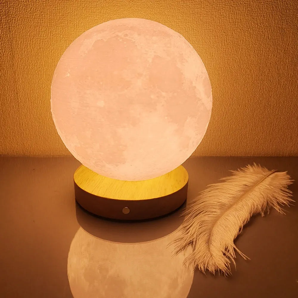 Rotating sleeping moon night lamp with wooden base showing three colour settings