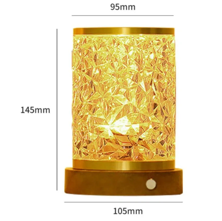 Small rotating water ripple night light with acrylic dome and solid wood base on a table.