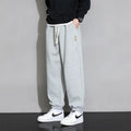 Men's loose fit grey sports trousers with drawstring waist and cotton-polyester blend fabric