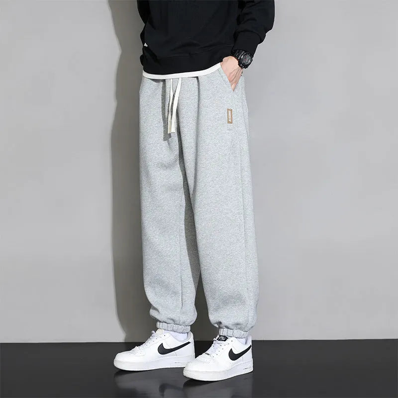 Men's loose fit grey sports trousers with drawstring waist and cotton-polyester blend fabric
