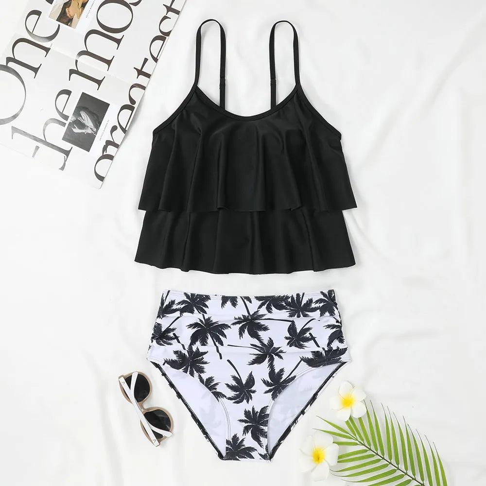 Black high-waisted double-layer swimsuit briefs and sleeveless top laid flat, with a coconut tree print variation.