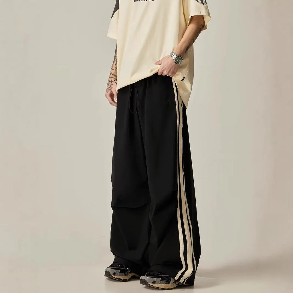 Black men's high-waisted wide-leg casual trousers laid flat.