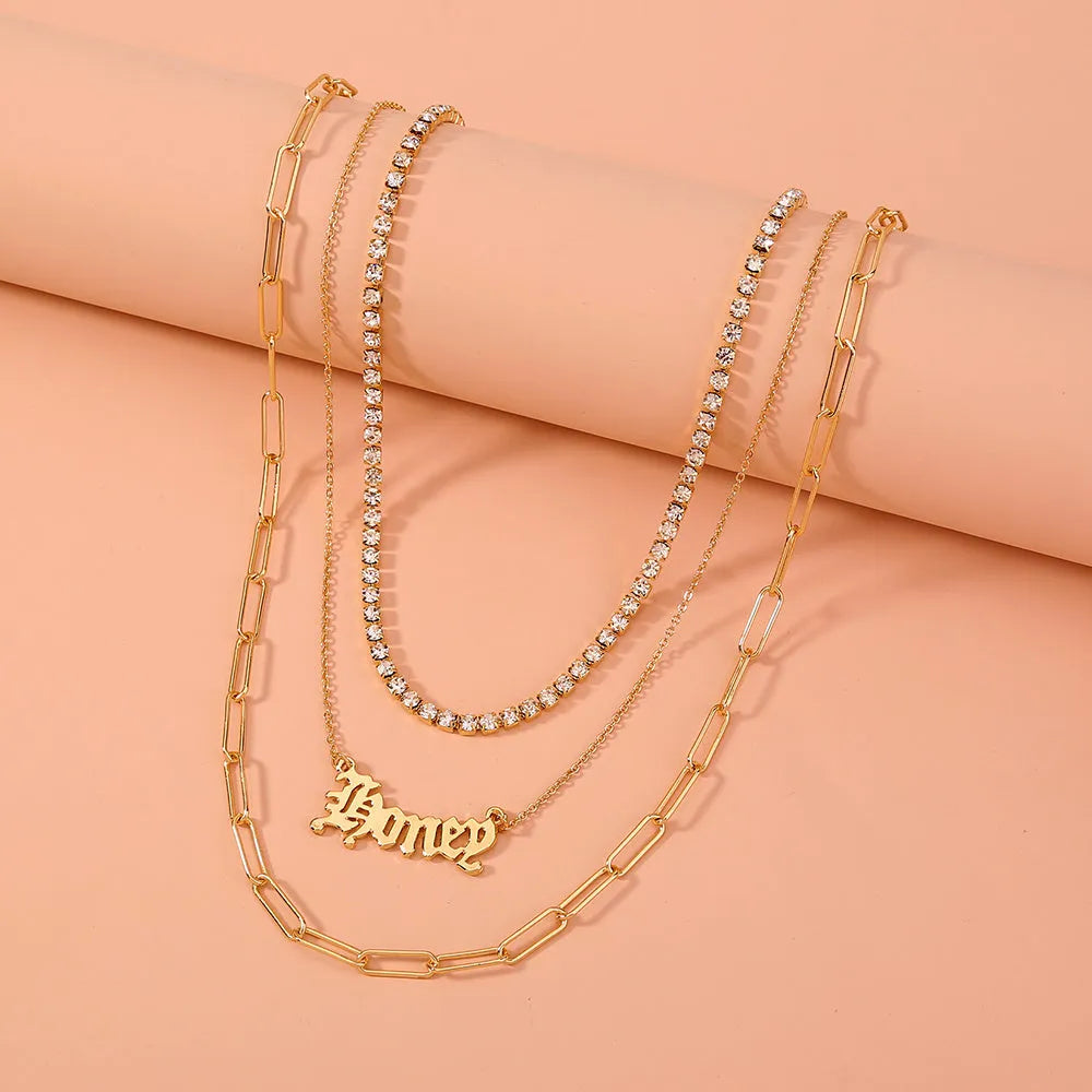 Monogram pendant multi-layer necklace on display showing electroplated zinc alloy chain and personalised initial