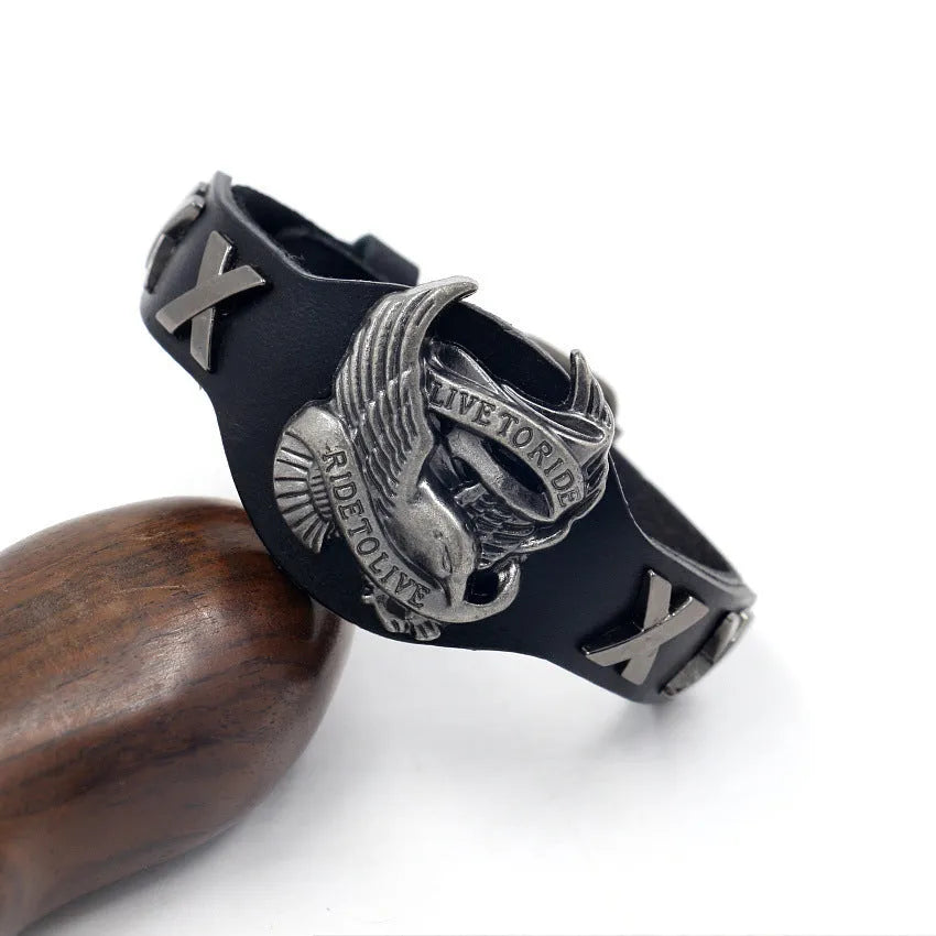 Black leather bracelet with a geometric alloy eagle decoration, showing the band's width variation.