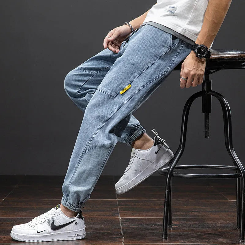 Man wearing loose straight-leg cargo jeans in blue, showing Korean-style casual workwear.