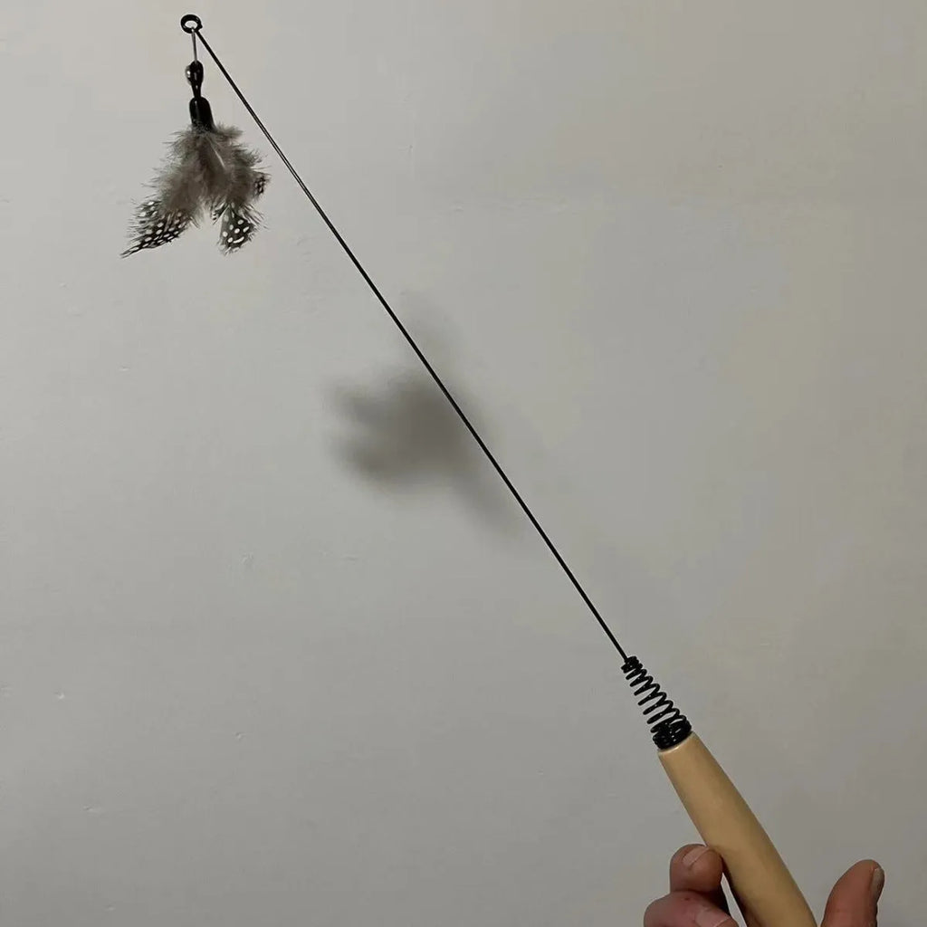 Cat teasing stick toy with wooden handle, bell, and feather head in selected colour