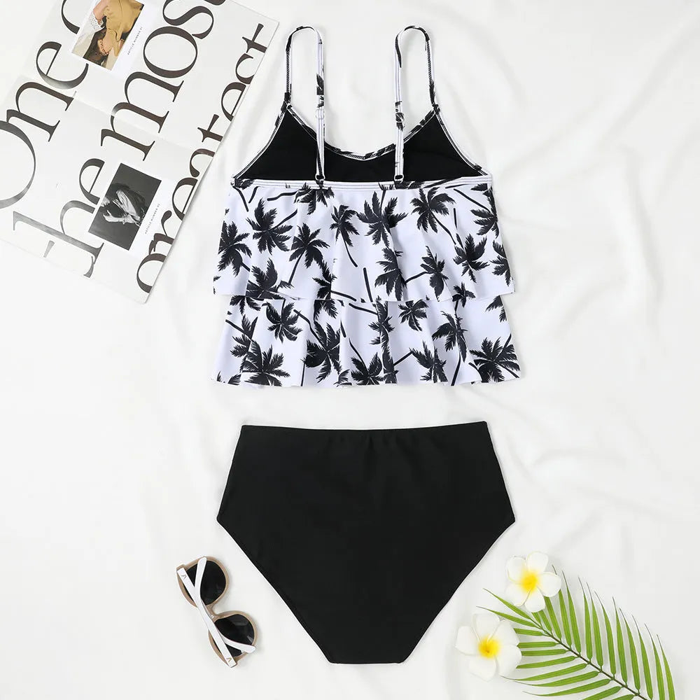 Black high-waisted double-layer swimsuit briefs and sleeveless top laid flat, with a coconut tree print variation.