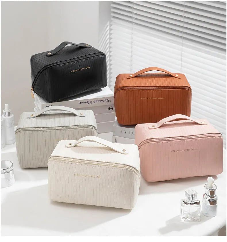 Vertical pattern pillow-shaped cubic makeup bag in PU material for women's travel storage.