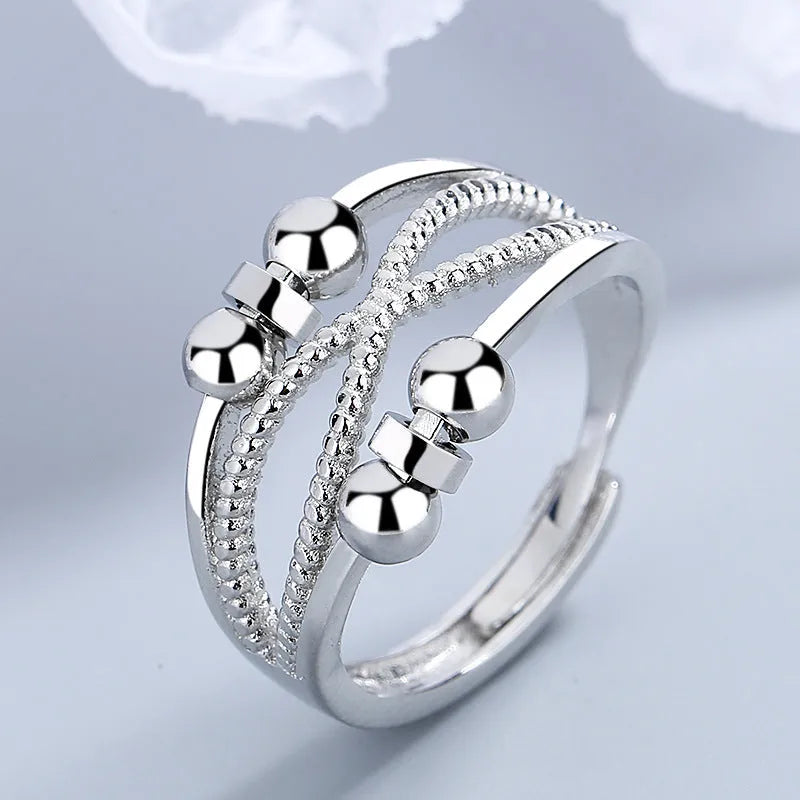 Rotatable copper ring with open design double-layered hollow line construction in platinum colour geometric shape