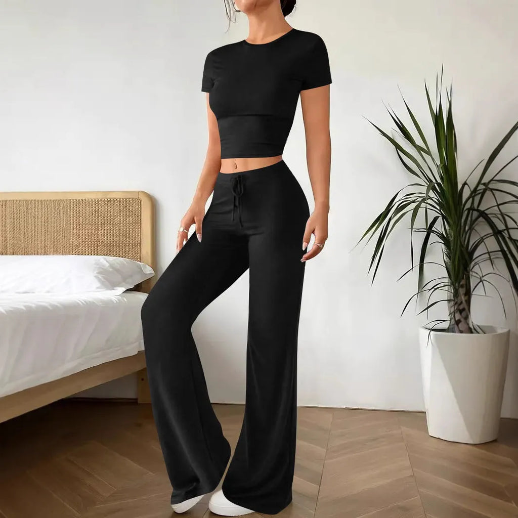 Black polyester two‑piece co‑ordination set with high‑waist trousers and a short‑sleeve t‑shirt.