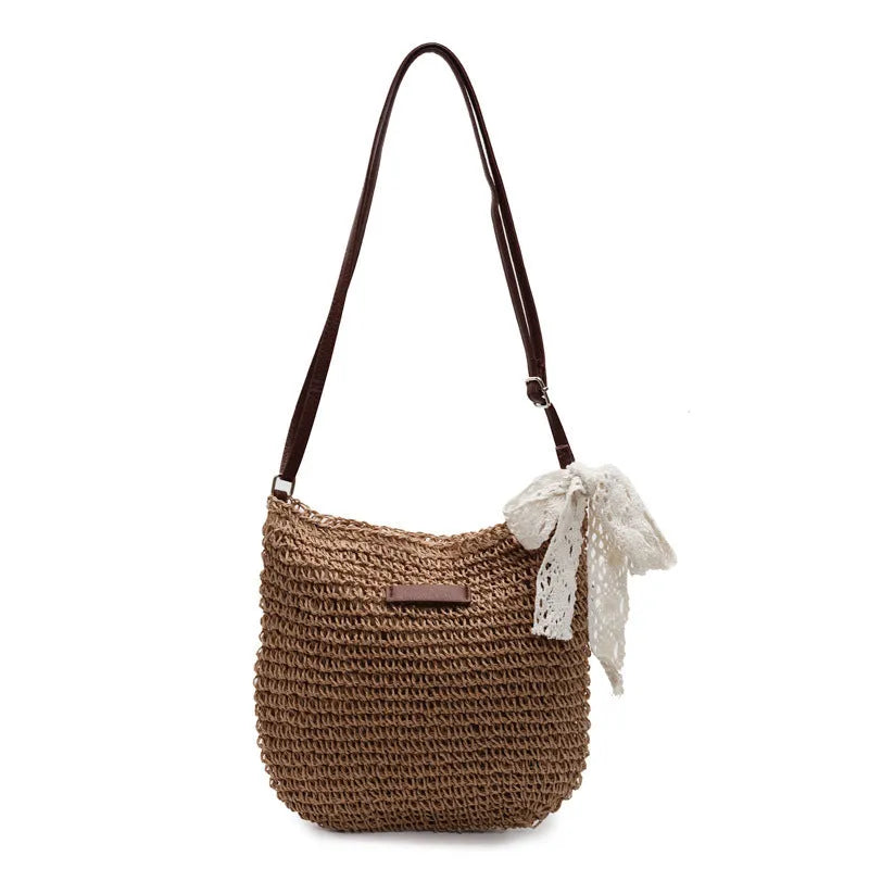 Women's straw woven messenger bag with hollowed design in khaki colour, showing vertical square shape and shoulder strap