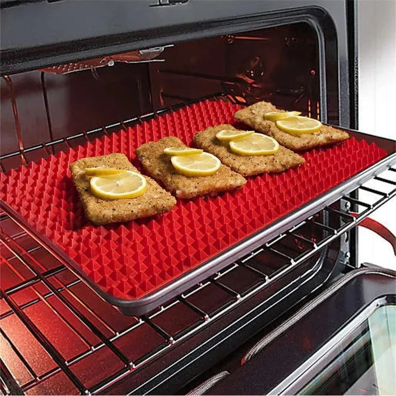 Red silicone pyramid grid cooking mat on a kitchen countertop.