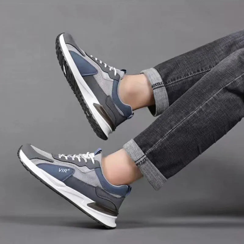 Men's black and grey colour block mesh running shoes with white soles on a plain background.