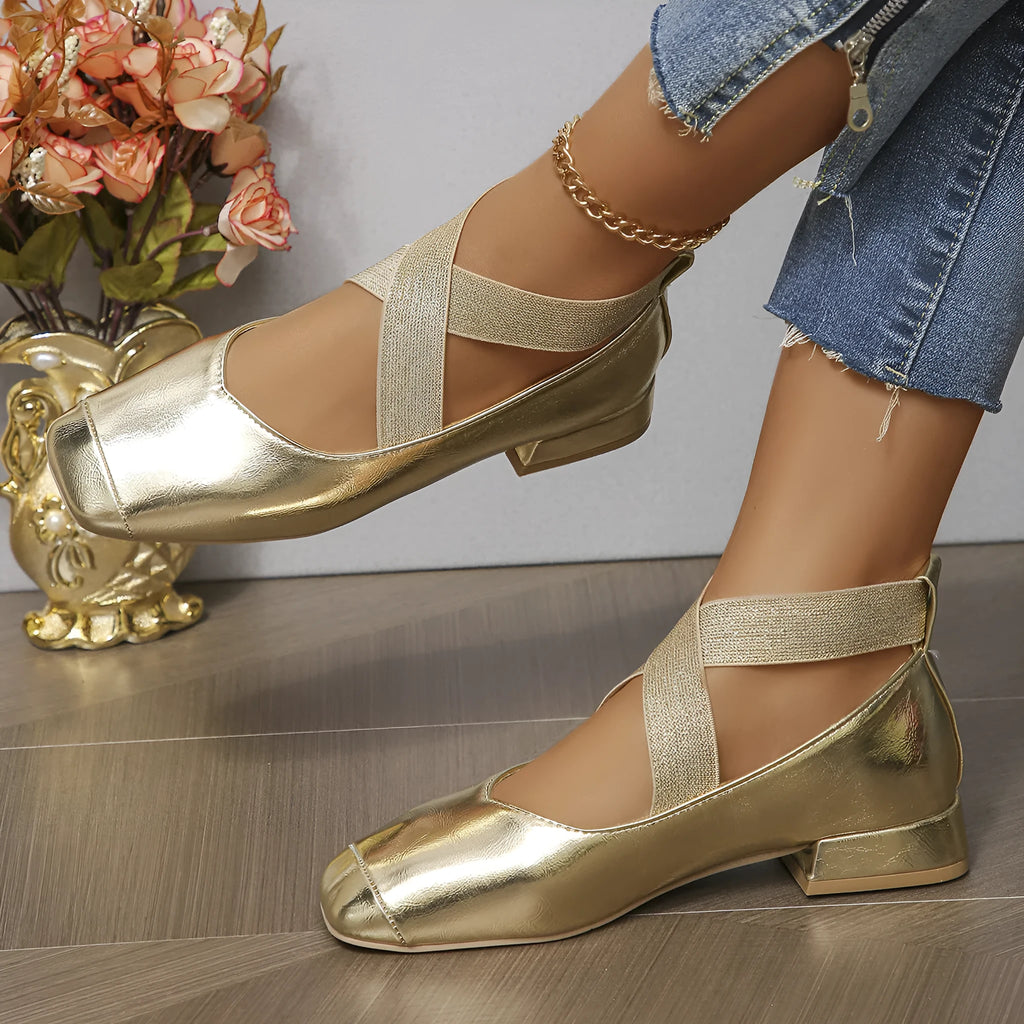 Gold slip-on evening pumps with a square toe and low heel on a plain background.